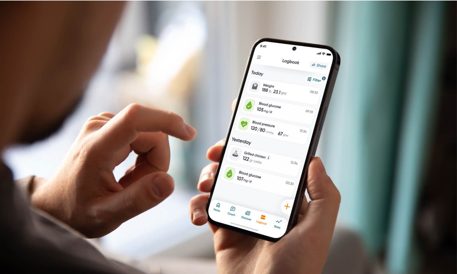 A person holding a phone showing the Dario app's daily logbook.